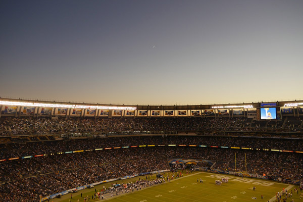 A football stadium filled with spectators at night