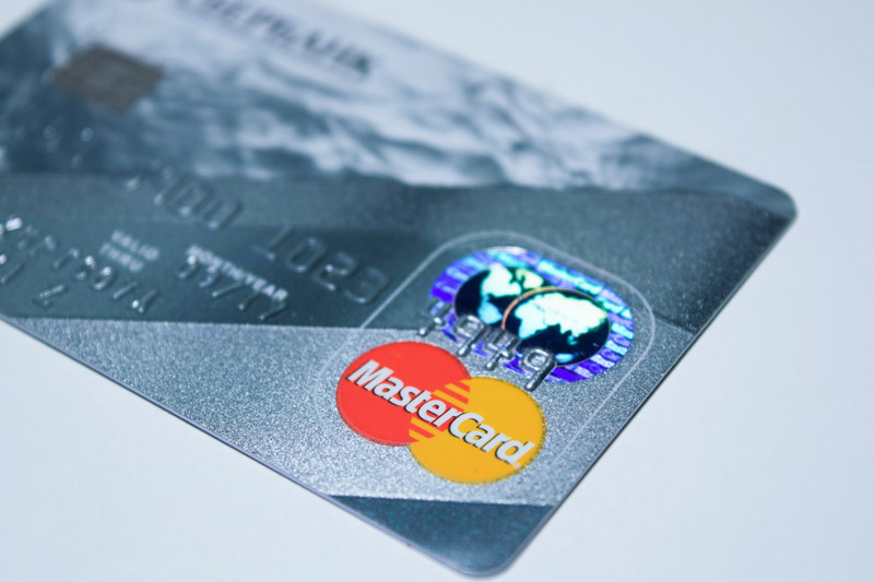 a close up image of a gray credit card with the Mastercard logo prominently on display